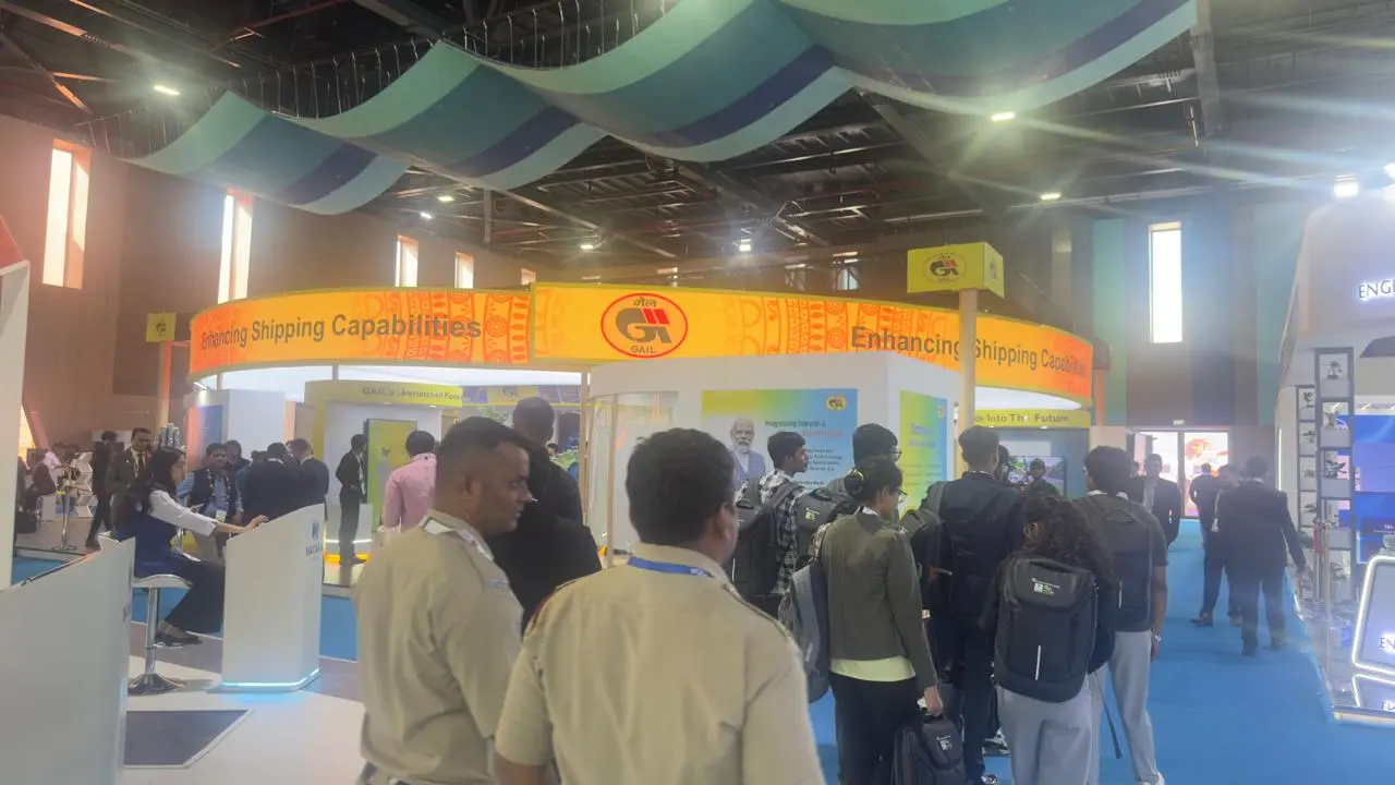 A scenic view of a sunset over a calm lake, with vibrant orange and purple hues reflected in the water.